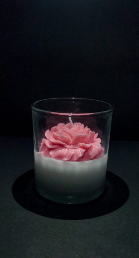 A scented candle that fills your space with soothing fragrance and warm light, creating a calming and cozy atmosphere
